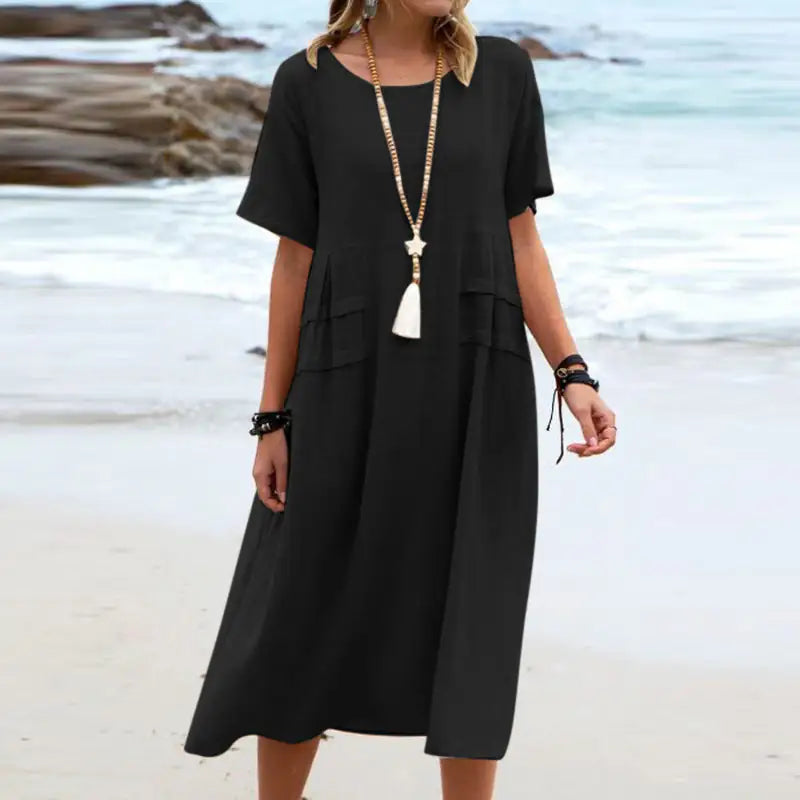 Woman wearing a black dress on a beach