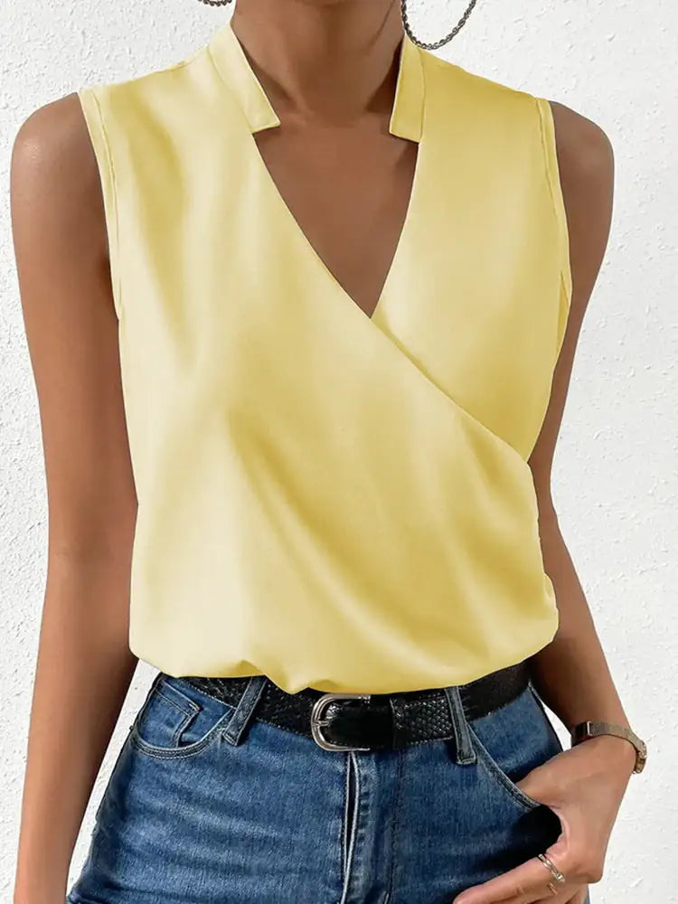 Yellow sleeveless top worn by a person on a white background